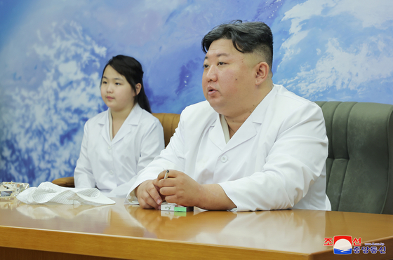 North Korean leader Kim Jong-un, right, inspects the country's first military satellite with his daughter Kim Ju-ae on Tuesday. [KOREAN CENTRAL NEWS AGENCY]