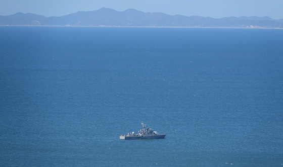 A South Korean Navy vessel patrols the area of the Northern Limit Line in the Yellow Sea in September 2020. The shoreline of North Korea's Hwanghae Province is visible in the distance. [YONHAP]