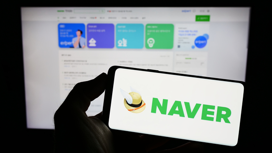 Person holding a cellphone with logo of Naver on screen [SHUTTERSTOCK]