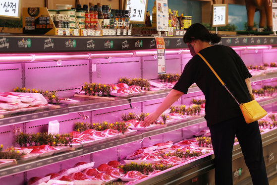 A person shops for meat products at a discount store in Seoul on May 18, 2023. [YONHAP]