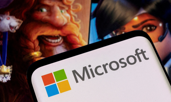 Microsoft's logo is seen on a smartphone placed on displayed Activision Blizzard's games characters in this illustration taken January 18, 2022. [REUTERS]