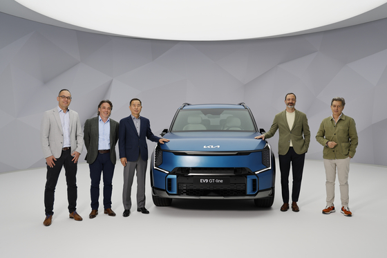 Kia executives including Jeong Won-jeong, third from left, who oversees the brand's European operations, pose with the Kia EV9 GT at the Kia Brand Summit in Germany on Tuesday. Kia will introduce the model in Europe in the second half, including a blue option and exterior designs unique to Europe. With the newest model, Kia hopes to sell 93,000 electric vehicles (EVs) in Europe this year, and 515,000 by 2030. EVs will account for 74 percent of its total sales in Europe by 2030. [KIA]
