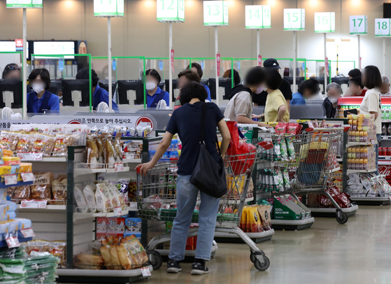Customers shop at a discount store in Seoul on Wednesday. [NEWS1]