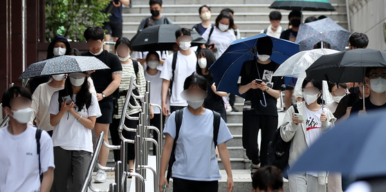 People walk out of Sungkyunkwan University in Seoul after they finish LEET on July 24, 2022. The number of applicants for the LEET reached a record high of 14,620 in 2022. [NEWS1] 