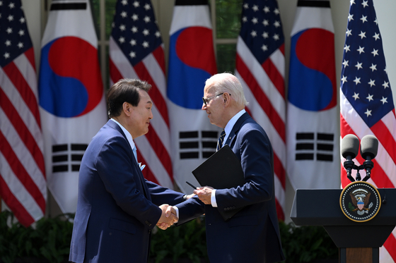 Korean President Yoon Suk Yeol shakes hands with U.S. President Joe Biden in the Rose Garden of the White House during their joint press conference on April 26. [JOINT PRESS CORPS]