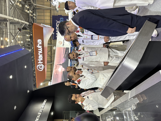 A delegation from Saudi Arabia listens to explanation at the Hanwha Ocean exhibition booth at Madex 2023 in Busan on Wednesday. [SEO JI-EUN]