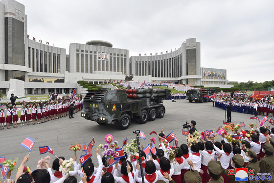Multiple rocket launchers donated by the Korean Children's Union moving along outside the Mangyongdae Children's Palace in Pyongyang on Tuesday. [KOREAN CENTRAL NEWS AGENCY]