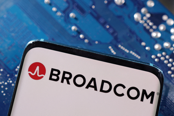 A smartphone with a displayed Broadcom logo is placed on a computer motherboard [REUTERS]