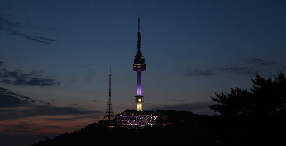 The N Seoul Tower in central Seoul is lit in purple on Monday, as part of the ″2023 BTS Festa″ held in celebration of K-pop boy band BTS's 10th anniversary of its debut. [YONHAP]