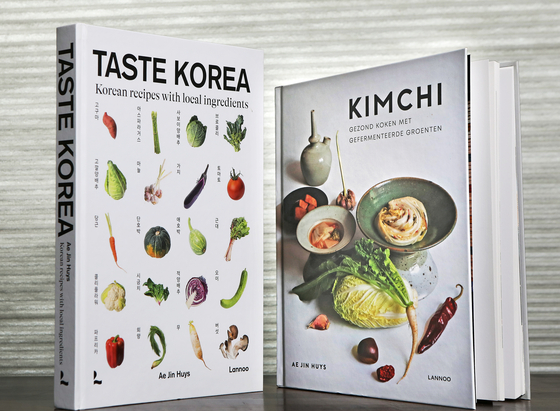 English translations of Ae Jin Huys' cookbooks "Taste Korea," left, and "Kimchi" (2019). [PARK SANG-MOON]