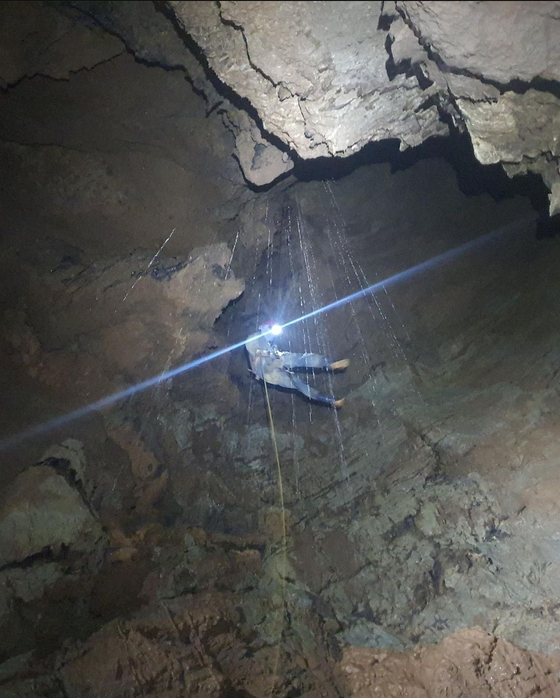 A member of the Cave Exploration Research Society explores a pit cave in Gangwon during a monthly expedition. [SCREEN CAPTURE]