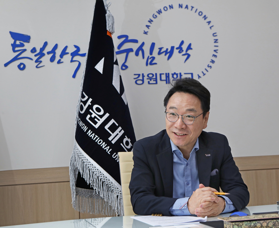 Kim speaks with the Korea JoongAng Daily during an interview in his office last month against a wall that reads “central university of a unified Korea." [PARK SANG-MOON]