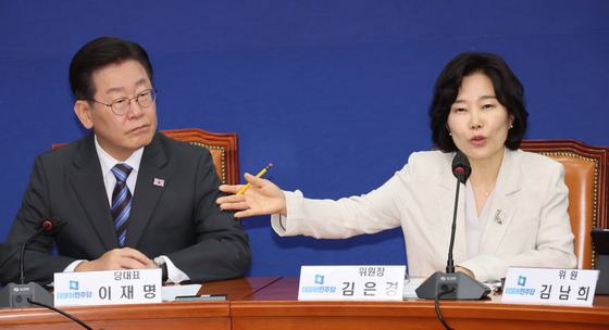 Kim Eun-kyung, right, professor of law at Hankuk University of Foreign Studies and the head of the Democratic Party's (DP) new innovation committee to revamp the party's image following several corruption scandals, and DP leader Lee Jae-myung attend a party meeting to launch the committee at the National Assembly in Seoul on Tuesday. [YONHAP] 