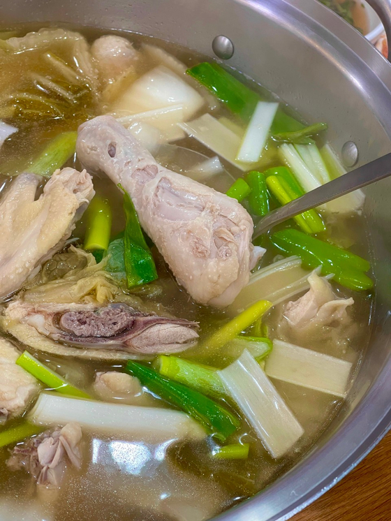 Dak hanmari, or whole chicken soup, sold at Hwangsaegol Sonkalguksu [HWANGSAEGOL SONKALGUKSU]