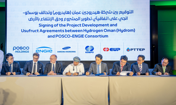 Executives of six companies in a Posco Holdings-led consortium and officials from the Oman government sign a deal on Wednesday in Duqm, Oman. [POSCO HOLDINGS]