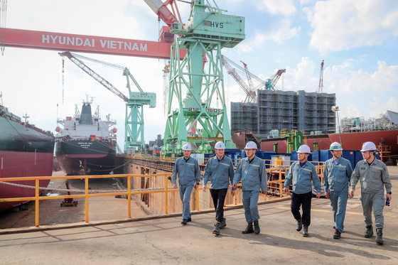 HD Hyundai CEO Chung Ki-sun, second from left poses with workers at Hyundai Vietnam Shipbuilding in Khanh Hoa, Vietnam, on Wednesday. [HD HYUNDAI]