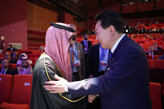 President Yoon Suk Yeol greets Saudi Foreign Minister Prince Faisal bin Farhan Al Saud at the Bureau International des Expositions' 172nd general assembly held at Issy-les-Moulineaux, near Paris, Tuesday. Korea and Saudi are considered the top contenders for hosting the World Expo in 2030. [JOINT PRESS CORPS]