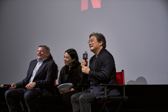 Left, Netflix co-CEO Ted Sarandos, and right, director Park Chan-wook, speak during an open talk session with film studies students held at a cinema in Yongsan District, central Seoul, on Wednesday. [NETFLIX]