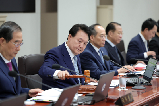 President Yoon Suk Yeol, center, presides over a Cabinet meeting at the Yongsan presidential office in central Seoul on Tuesday, after completing a trip to Paris and Hanoi last week. [JOINT PRESS CORPS]