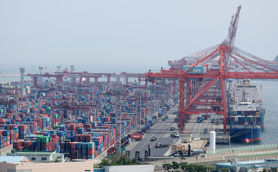 Containers are stacked at a port in Busan. [YONHAP]