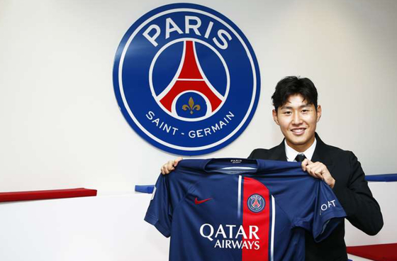 Lee Kang-in poses with a Paris Saint-Germain shirt in a photo released by the club on Saturday.  [PARIS SAINT-GERMAIN]