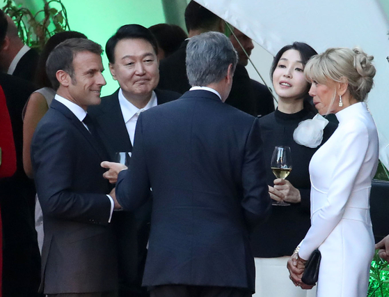 Korean President Yoon Suk-yeol, center left, and first lady Kim Keon-hee, center right, mingle with other foreign leaders and their spouses at a dinner event during the NATO summit in Vilnius, Lithuania on Tuesday. [JOINT PRESS CORPS]