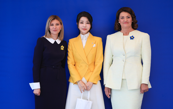 Korean first lady Kim Keon-hee, center, poses for a photo with Ukrainian first lady Olena Zelenska, left, and Lithuania’s Diana Nausediene, right, at the Ukrainian Center in Vilnius, Lithuania, on Wednesday on the sidelines of the NATO summit. Kim and Zelenska met in Seoul in May. [JOINT PRESS CORPS]