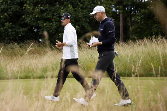 Rickie Fowler and Justin Thomas walk off the 4th tee during a practice round prior to the Genesis Scottish Open at The Renaissance Club in North Berwick, Scotland on Tuesday.  [GETTY IMAGES]
