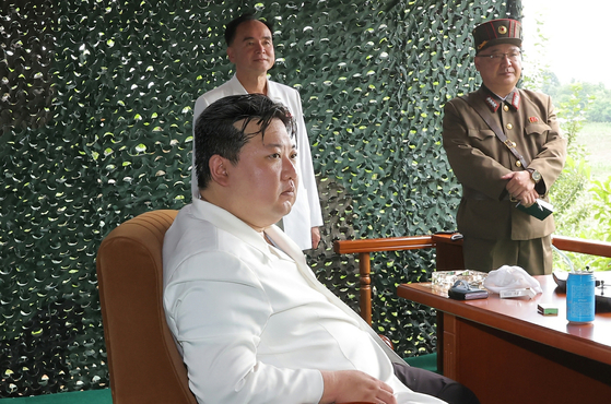 North Korean leader Kim Jong-un watches the launching of an intercontinental ballistic missiles fired on Tuesday. The photo, which was released by the Korean Central News Agency, shows a foldable smartphone placed on the corner of the desk. [KOREAN CENTRAL NEWS AGENCY]
