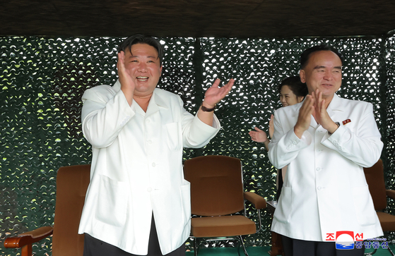 In this photo released by the Korean Central News Agency, North Korean leader Kim Jong-un, left, celebrates the launch of the Hwasong-18 solid-fuel intercontinental ballistic missile on Wednesday. [YONHAP]