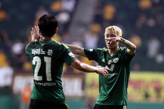 Jeonbuk Hyundai Motors' Song Min-kyu, right, celebrates with Jun Amano during an FA Cup match against Gwangju FC at Jeonju World Cup Stadium in Jeonju, North Jeolla on June 28. [YONHAP]  