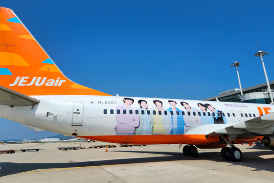 The outside of a Jeju Air plane is decorated with an image of BTS members and the "BTS Presents Everywhere" slogan to promote the "2023 BTS Festa" that celebrates the 10th debut anniversary of the boy band. The budget carrier announced Wednesday that it will take part in the celebration as a partnering company and said all of its international flights will be decorated with BTS until the end of this year. [NEWS1]