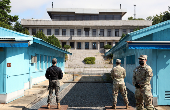 A South Korean soldier, left, and a U.S. soldier, right, face the North Korean side of the Joint Security Area (JSA) while a United Nations Command officer leads a tour of the truce village of Panmunjom in Paju, South Korea on Oct 4, 2022. [JOINT PRESS CORPS]
