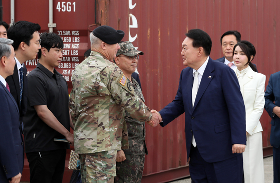 President Yoon Suk Yeol, right, accompanied by first lady Kim Keon-hee, shakes hands with Gen. Paul LaCamera, commander of the U.S. Forces Korea (USFK), left, at a naval base in Busan to tour a U.S. nuclear-capable ballistic missile submarine Wednesday. [JOINT PRESS CORPS]