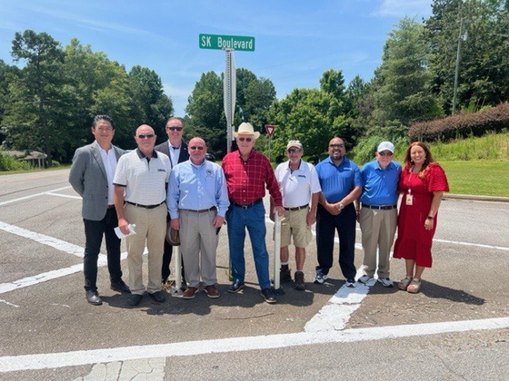 Clark Hill, third from left, mayor of Georgia's City of Commerce, and SK On executives, take a photo on SK Boulevard, Wednesday. [SK ON] 