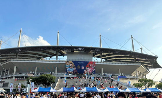 Fans gather in the thousands outside Seoul World Cup Stadium in western Seoul on Thursday ahead of a Coupang Play Series game between Atletico Madrid and Team K League.  [JIM BULLEY]