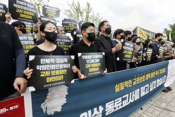 A group of teachers hold a press conference in front of the National Assembly in Yeouido, western Seoul, on Thursday afternoon, urging measures to better protect teachers’ rights. [NEWS1]