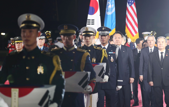 President Yoon Suk Yeol, third from right, attends a repatriation ceremony marking the return of the remains of seven South Korean troops killed in the 1950-53 Korean War from the United States on Wednesday evening at Seoul Air Base in Seongnam, Gyeonggi. The remains were transported on a KC-330 tanker transport plane after a handover ceremony in Hawaii the previous day. [JOINT PRESS CORPS]