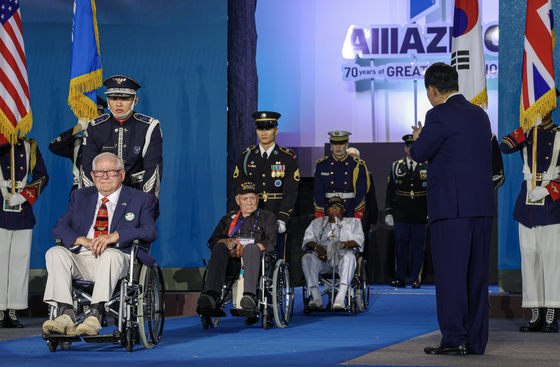 Korean War veterans enter the stage in a ceremony commemorating the 70th anniversary of the Armistice Agreement at Busan Cinema Center Thursday. [JOINT PRESS CORPS]