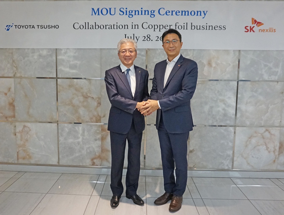 SKC CEO Park Won-cheol, right, poses for a photo with Ichiro Kashitani, president and CEO of Toyota Tsusho, during a signing ceremony for their partnership on copper foil manufacturing in the United States in Nagoya, Japan, on July 28. [SKC]