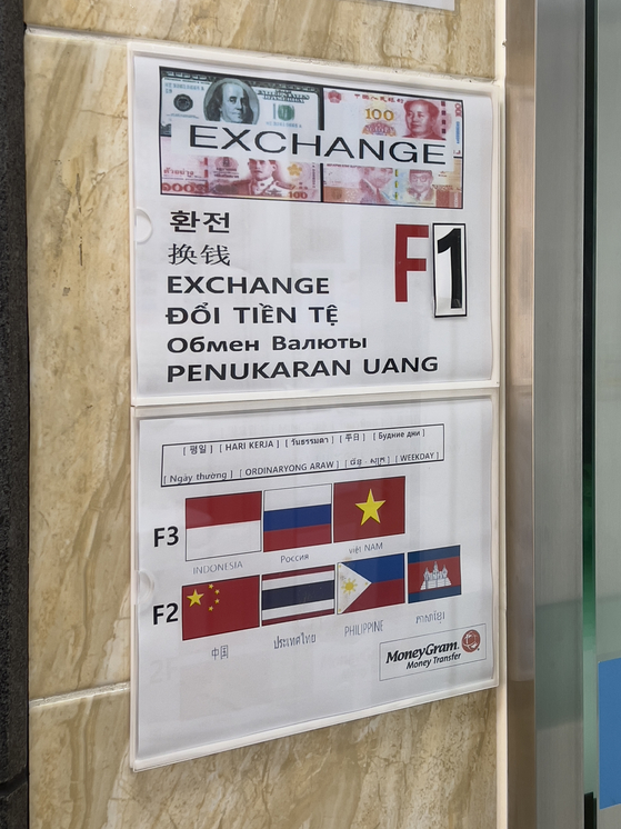 A sign at Woori Bank's branch in Ansan, Gyeonggi, shows the different languages bank tellers can speak [LEE TAE-HEE]