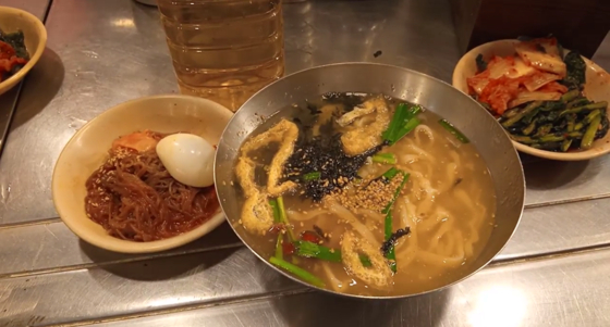 Kalguksoo (knife-cut noodles) at HyungJaeBunSik, served with naengmyeon and kimchi [SHAKERRA BARTLEY]