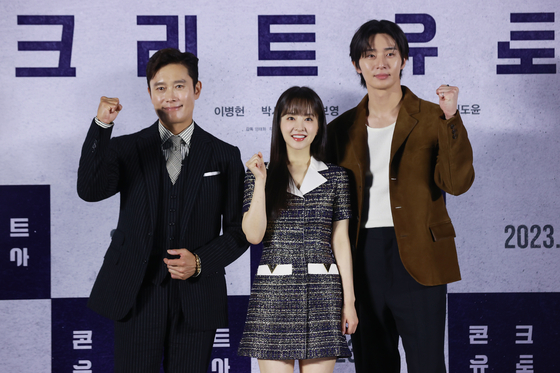 From left, actors Lee Byung-hun, Park Bo-young and Park Seo-jun pose for a photo during the press conference for ″Concrete Utopia″ at Lotte Cinema Konkuk University branch in Gwangjin District, eastern Seoul on Wednesday. [YONHAP]