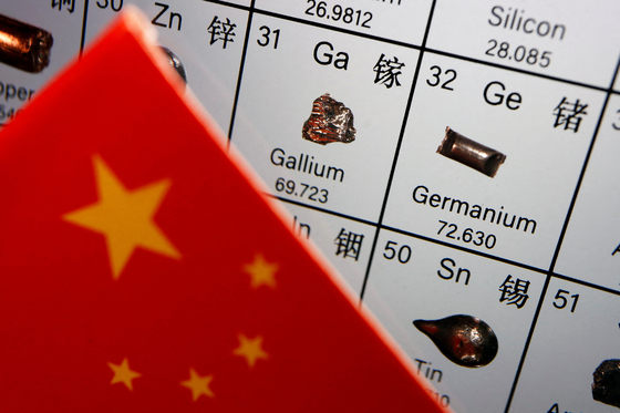 The flag of China is placed next to the elements of Gallium and Germanium on a periodic table. [REUTERS]