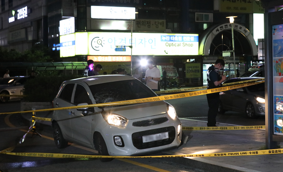 Police investigate a mini compact car that Choi, a 22-year-old assailant, drove to hit five people before injuring nine more with his knife Thursday. [NEWS1]