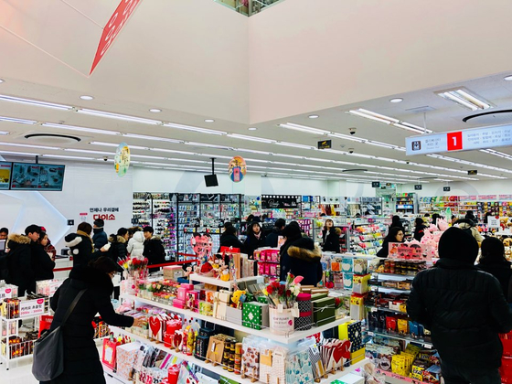 Shoppers buy goods at a Daiso store, a low-cost chain. [DAISO]