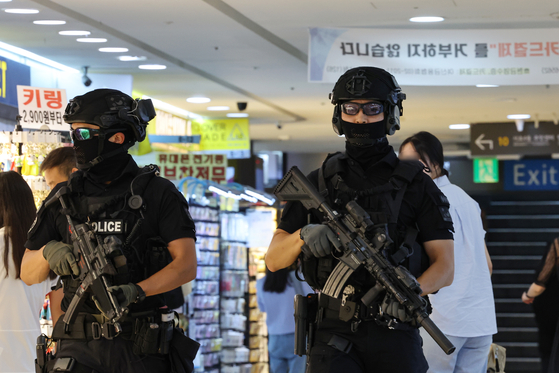 Armed police patrols Gangnam subway station on Sunday. [YONHAP]