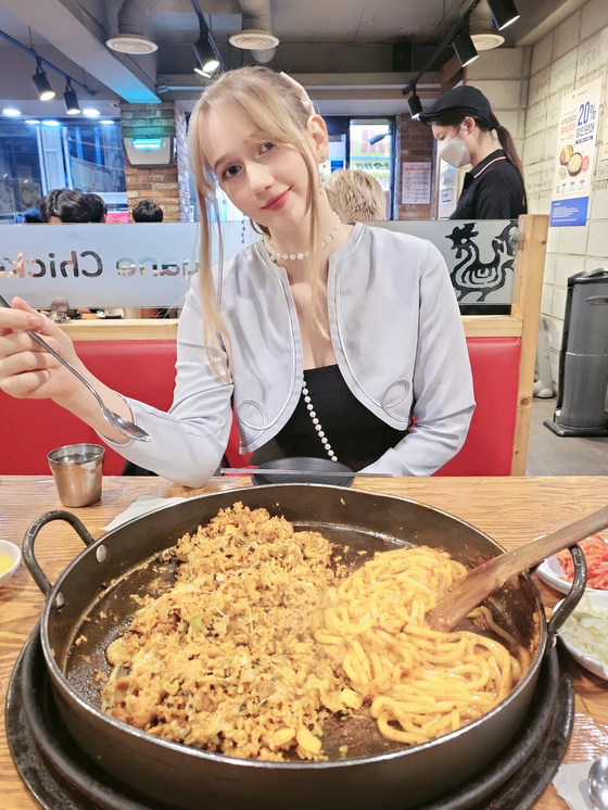 A twenty-four-year-old Estonian, whose online moniker is Mai poses for a photo after a meal in a Korean restaurant. Mai runs her own YouTube channel, “Kimchi Ghost Mai,” which has about 26,900 subscribers. [KIMCHI GHOST MAI]
