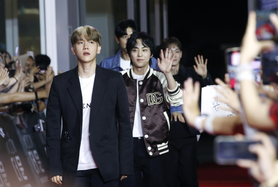 Baekhyun, a member of boy band EXO along with his bandmate Xiumin behind him, at the Times Square shopping mall in western Seoul on July 25 [NEWS1]