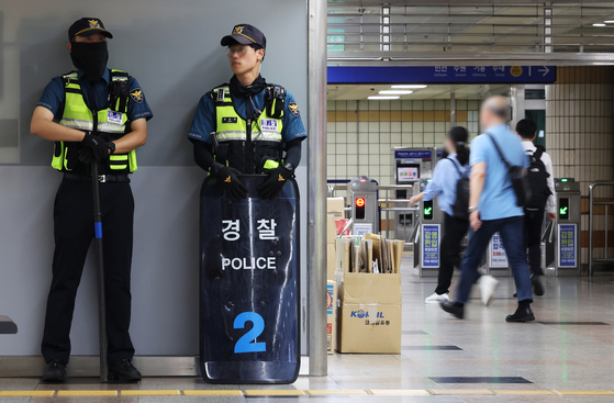 Armed police officers are stationed at Seohyeon Station in Seongnam, Gyeonggi, on Friday. [YONHAP]